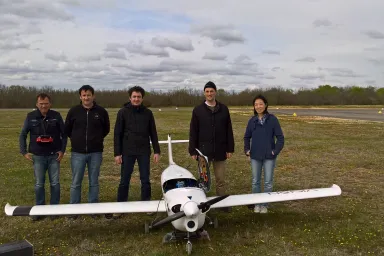 ONERA and SZTAKI members with the K50 aircraft. SZTAKI 2 camera system can be seen under the wings and the japanise RICOH stero sensor under the body.